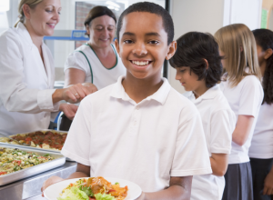 School child with healthy school lunch